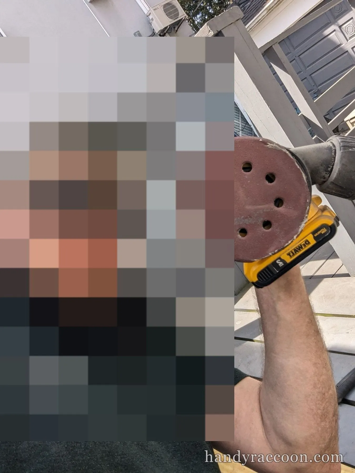 Man in cap and sunglasses holding a cordless orbital sander outdoors on a deck.