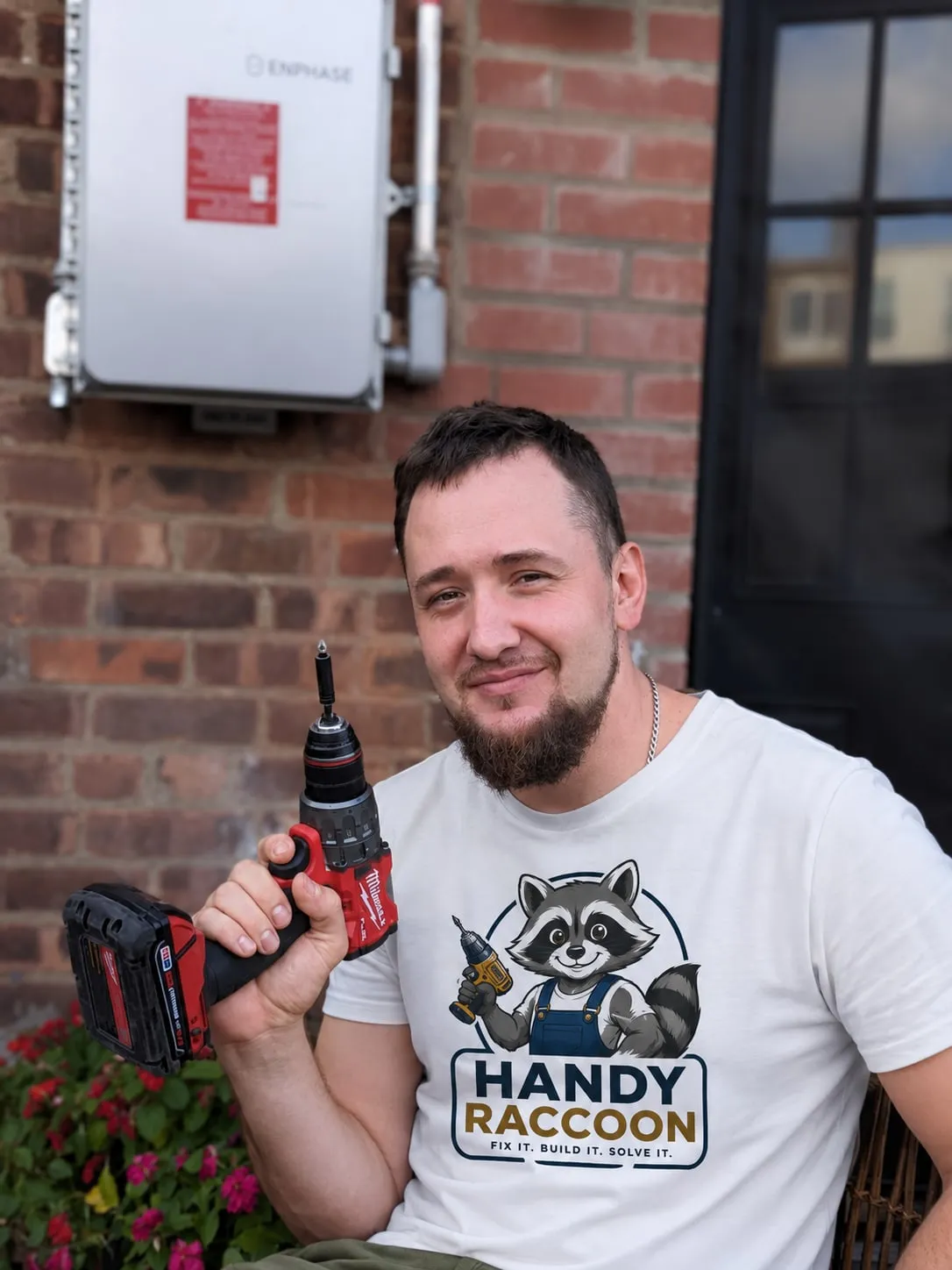 Konstantin, the handyman, holding a cordless drill outside a Brooklyn building